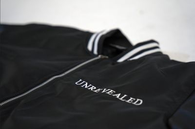 "UNREVEALED" VARSITY JACKET